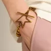 Bracciale con catena a maglie decrescenti in oro antico e chiusura a forma di stella