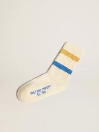 Calzini bianchi da bambino con dettagli consumati e strisce bicolori blu brillante e senape
