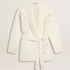 Cardigan da donna in cotone color crema con ricami floreali Cardigan da donna in cotone color crema con ricami floreali