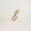 Ciondolo a forma di lettera U in ottone dorato con cristalli Ciondolo a forma di lettera U in ottone dorato con cristalli