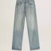 Jeans da donna lavati con occhielli su tutta la superficie