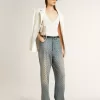 Jeans da donna lavati con occhielli su tutta la superficie