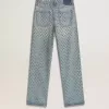 Jeans da donna lavati con occhielli su tutta la superficie