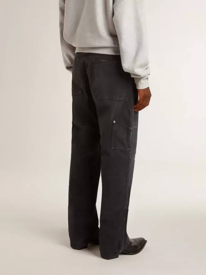 Jeans da uomo in cotone nero effetto consumato con toppe frontali
