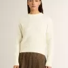 Maglione da donna con collo a giro in lana merino bianca con cristalli su tutta la superficie Maglione da donna con collo a giro in lana merino bianca con cristalli su tutta la superficie