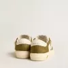 May Young in pelle bianca e verde militare