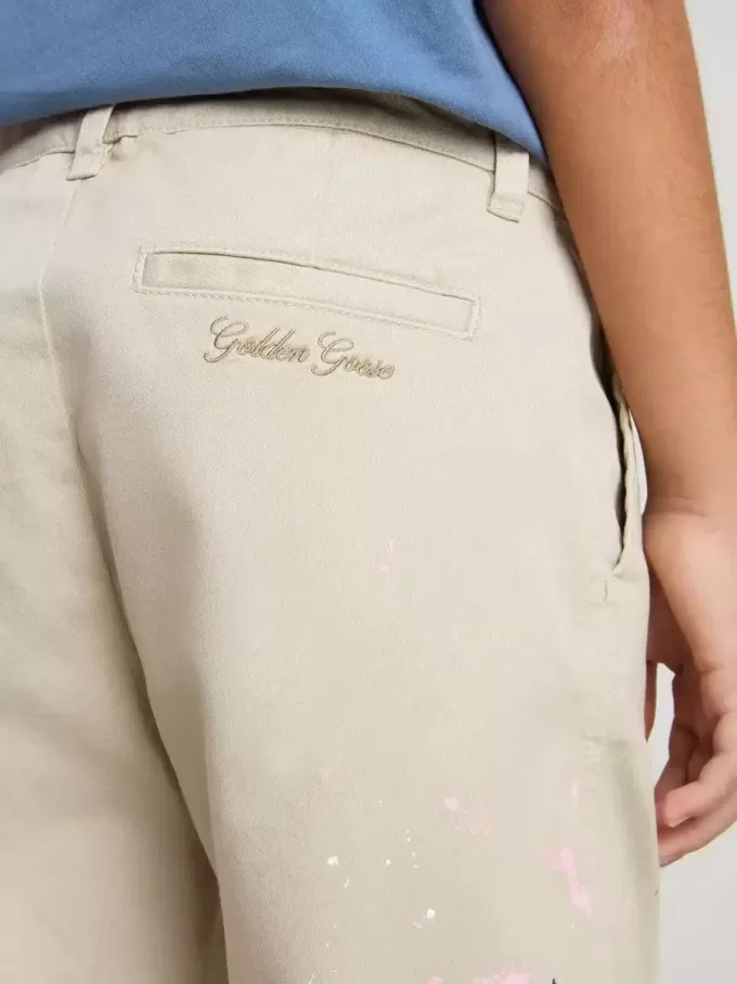 Pantaloni chino beige per bambino con spruzzi multicolori