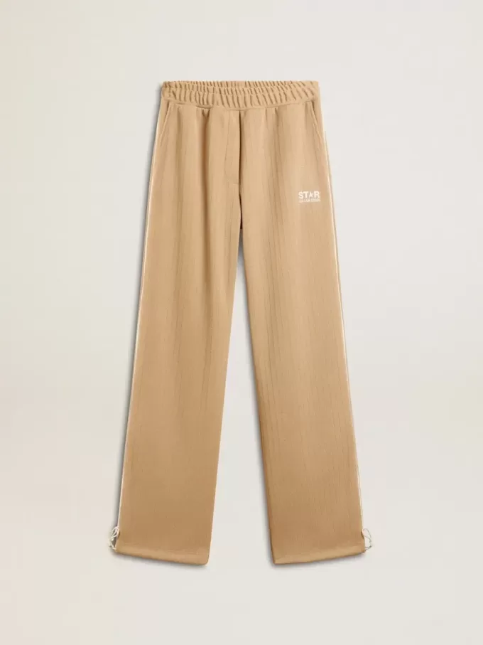 Pantaloni jogging da donna beige chiaro con logo bianco Pantaloni jogging da donna beige chiaro con logo bianco