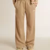 Pantaloni jogging da donna beige chiaro con logo bianco Pantaloni jogging da donna beige chiaro con logo bianco