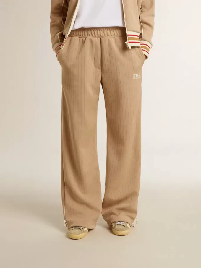 Pantaloni jogging da donna beige chiaro con logo bianco Pantaloni jogging da donna beige chiaro con logo bianco