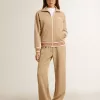 Pantaloni jogging da donna beige chiaro con logo bianco Pantaloni jogging da donna beige chiaro con logo bianco