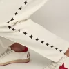 Pantaloni jogging da uomo bianchi con stelle nere sui lati Pantaloni jogging da uomo bianchi con stelle nere sui lati