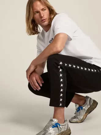Pantaloni jogging da uomo neri con stelle bianche sui lati Pantaloni jogging da uomo neri con stelle bianche sui lati
