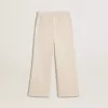 Pantaloni larghi a coste color crema con ricami per bambina Pantaloni larghi a coste color crema con ricami per bambina