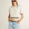 Polo da donna corta in cotone bianco consumato con bordi blu Polo da donna corta in cotone bianco consumato con bordi blu