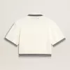 Polo da donna corta in cotone bianco consumato con bordi blu Polo da donna corta in cotone bianco consumato con bordi blu