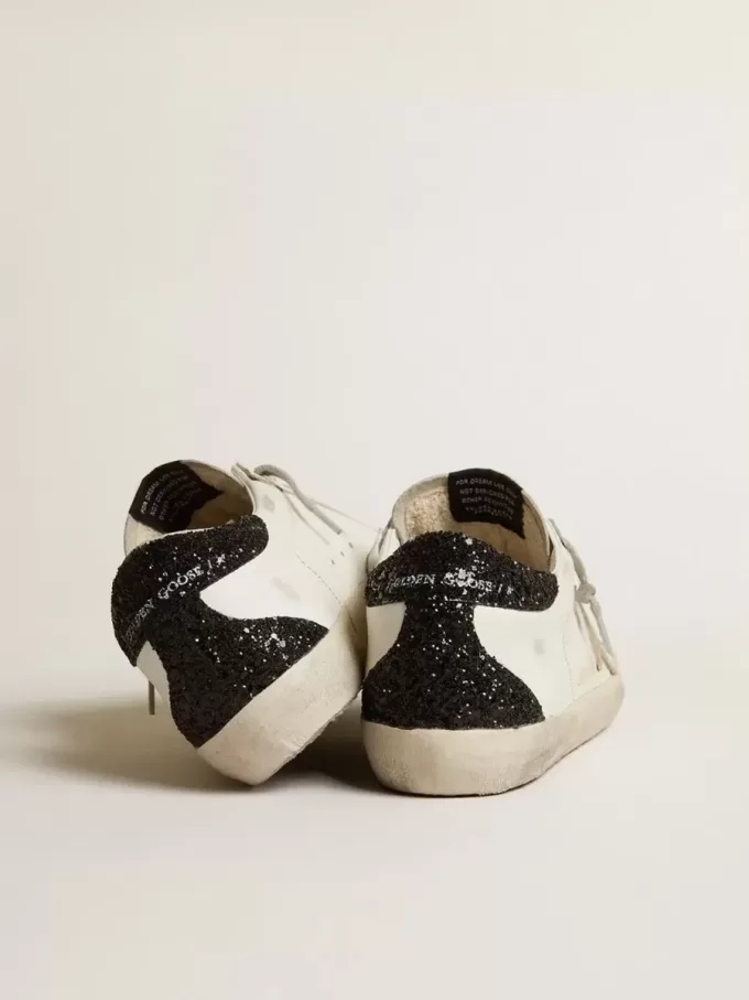 Super-Star da donna con stella dorata e tallone nero glitterato