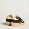 Super-Star da donna in nero glitterato e nappa con stella e tallone in pelle color crema Super-Star da donna in nero glitterato e nappa con stella e tallone in pelle color crema