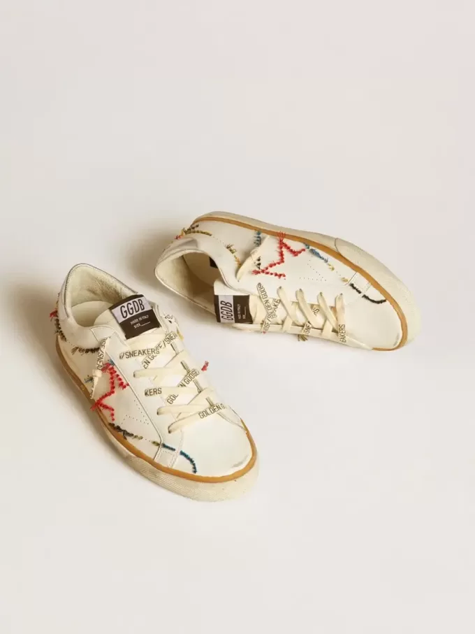 Super-Star LTD da donna con stella traforata e linguetta sul tallone in pelle metallizzata Super-Star LTD da donna con stella traforata e linguetta sul tallone in pelle metallizzata