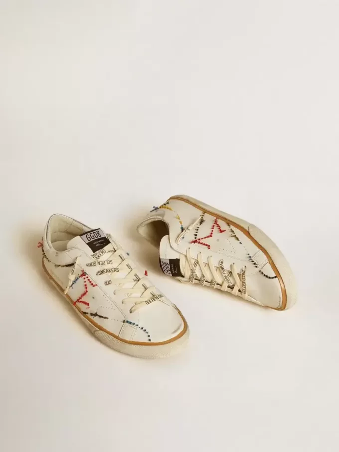 Super-Star LTD da uomo con stella traforata e linguetta sul tallone in pelle metallizzata Super-Star LTD da uomo con stella traforata e linguetta sul tallone in pelle metallizzata