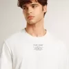 T-shirt da uomo in cotone bianco consumato con scritte nere T-shirt da uomo in cotone bianco consumato con scritte nere