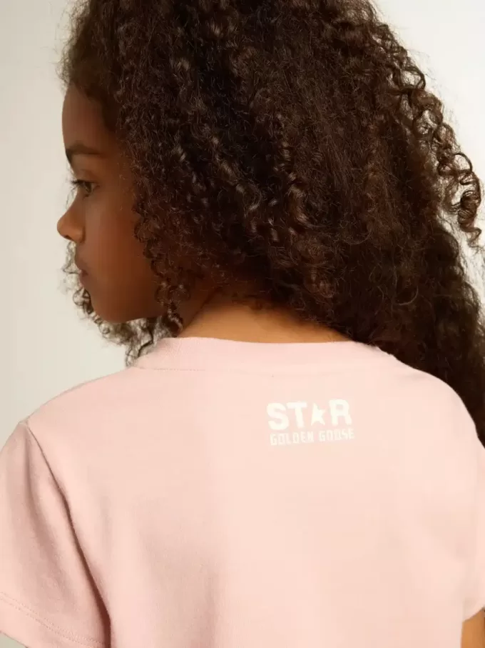 T-shirt rosa da bambina con logo bianco e maxi stella T-shirt rosa da bambina con logo bianco e maxi stella