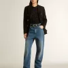 Top in maglia nera con paillettes e dettagli a contrasto