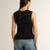 Top in maglia nera con paillettes e dettagli a contrasto